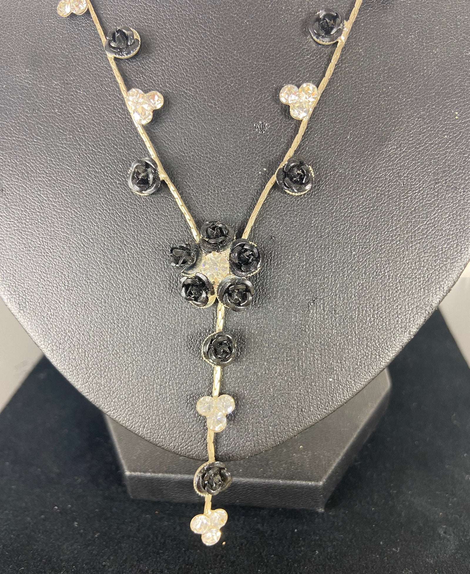 Collier long de fleurs noires et brillantes sur chaine plate argentée